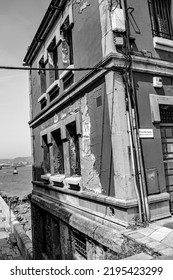 Gijon, Spain. June 16th 2022. A Rough  Building Taken At A Side Street In Gijon With A Sea View In Black And White.