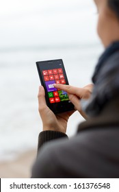 GIJON, SPAIN- November 04, 2013: Woman Touching Nokia Lumia 1020 Screen.  The Windows Phone 8 Smart Phone Features Nokia's Pureview 41 Megapixels Camera.