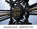 gilded cross of fallen fighters in the First World War. 1914 and 1918. Circular die-cast metal emblem. renovation of historical war graves with painted paint. Austria-Hungary, graveyard, number