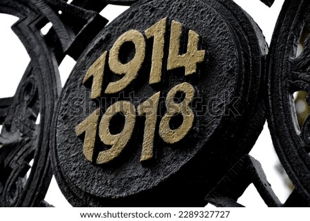 gilded cross of fallen fighters in the First World War. 1914 and 1918. Circular die-cast metal emblem. renovation of historical war graves with painted paint. Austria-Hungary, graveyard, number