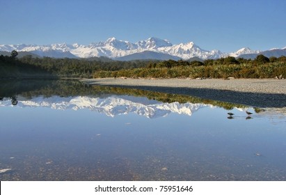 Gillespies Lagoon On The West Coast Of New Zealand, Reflecting Mt. Cook And Mt. Tasman, New Zealand's Highest Mountains.