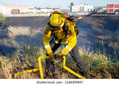 Gilroy, California June 15,2022: Gilroy And Cal Fire Fire Fighters Connecting Hose To Help Put Out A Grass Fire