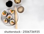 Gimbap or kimbap, korean rolls, traditional dish. Homemade kimbap roll with ham, vegetables and lettuce