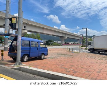 Gimhae, South Korea - August 6 2022 : Blue Car Box Car Flyover Electric Pole Clear Sky