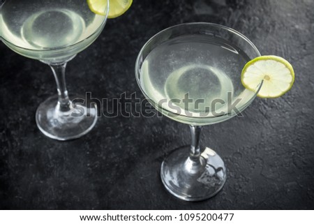 Gimlet Cocktail. Alcoholic Lime and Gin Gimlet on black background, copy space.