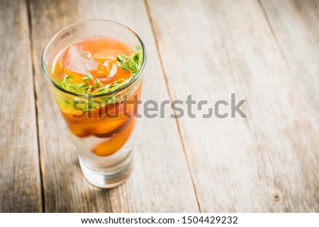 Gin based cocktail with peaches and thyme. Selective focus. Shallow depth of field.