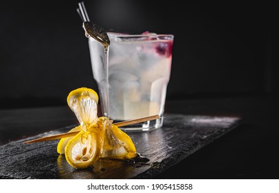 Gin Cocktail With Lemon And Honey On Black Background 