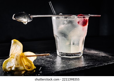 Gin Cocktail With Lemon And Honey On Black Background