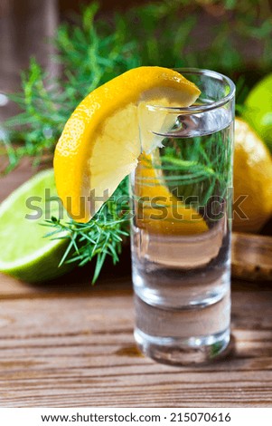 Gin with lemon on a old wooden table