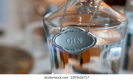 Gin tag on a glass bottle full of gin.   - Powered by Shutterstock