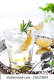 Gin, Tonic, Lemon, Rosemary Fizz, Cocktail With Honey And Fresh Herbs On A White Background.