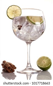 Gin Tonic With Lime And Cinnamon Sticks  On White Background