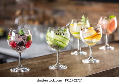 Gin tonic long drink as a classic cocktail in various forms with garnish in individual glasses such as orange, lemon, grapefruit, cucumber or berries.