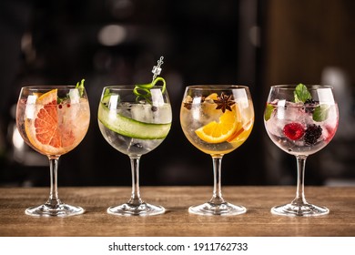 Gin tonic long drink as a classic cocktail in various forms with garnish in individual glasses such as orange, grapefruit, cucumber or berries. - Shutterstock ID 1911762733