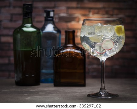 Gin and tonic on a wooden table with bricks background