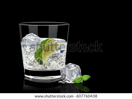 Gin tonic or vodka lime and basil isolated on black background