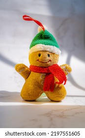 Ginger Bread Man Plush Doll Isolated On White Marble Surface Under Sun Light From Window