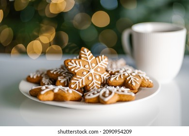 Ginger Christmas cookies on the background of a Christmas tree with lights. - Powered by Shutterstock