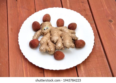 Ginger. Ginger With Eyes. On A Plate. On A Wooden Background. Fruit Carving. Place For Text. Table Decoration. Healthcare And Alternative Medicine.