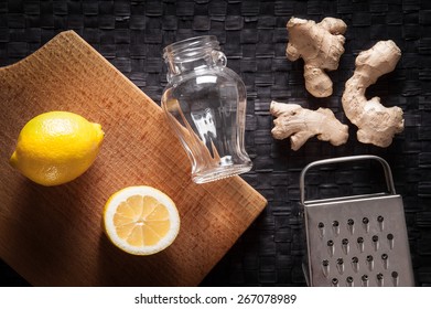 Ginger, Lemon, Grater And Jar On Table