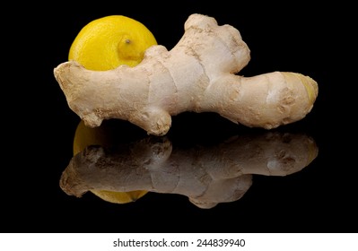 Ginger and lemon on a black background with reflection