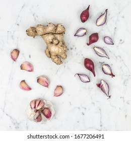 Ginger, Onion and Garlic on Marble Background