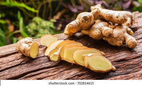 Ginger root - Fresh ginger root and sliced on old plank with nature background. Close-up, Selective focus