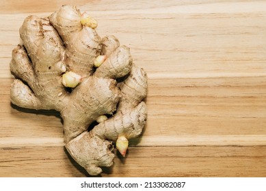 Ginger Root With Growing Sprouts On A Wooden Board