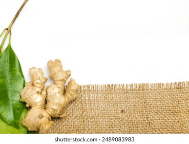 Ginger root isolated on burlap fabric background.Ideal for use in health, culinary and content , Background template - Powered by Shutterstock