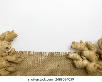 Ginger root isolated on burlap background.Ideal for use in health, culinary and content , Background template - Powered by Shutterstock