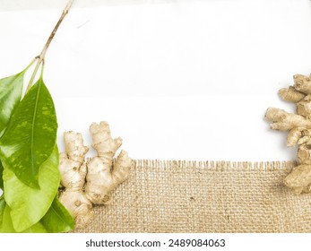 Ginger root isolated on burlap fabric background.Ideal for use in health, culinary and content , Background template - Powered by Shutterstock