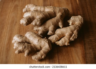Ginger root on wooden background with selective focus. 
