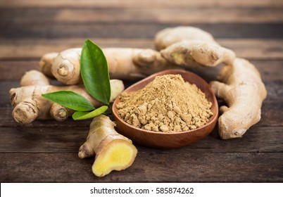 Ginger root and ginger powder in the bowl - Shutterstock ID 585874262