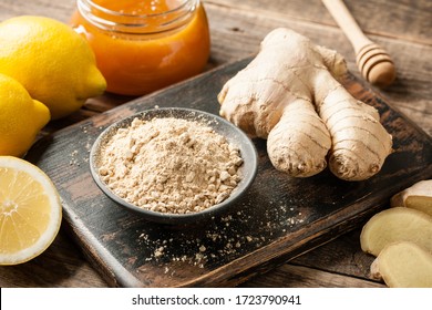 Ginger root, ginger powder, honey and fresh  lemons on wooden table - Powered by Shutterstock