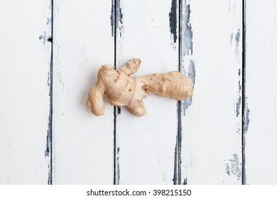 Ginger Rot On White Wooden Background