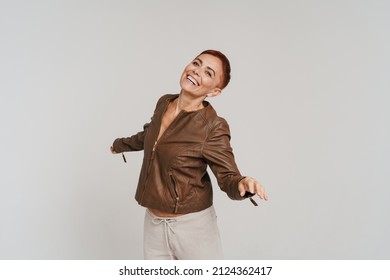 Ginger Senior Woman With Short Hair Smiling And Dancing Isolated Over White Background