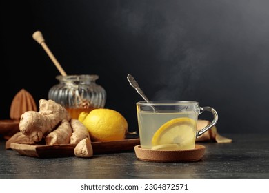 Ginger tea with lemon and honey on a black background. - Powered by Shutterstock