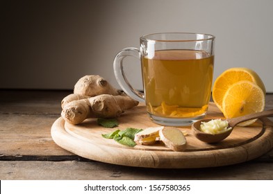 Ginger tea with lemon on a wooden table - Shutterstock ID 1567580365