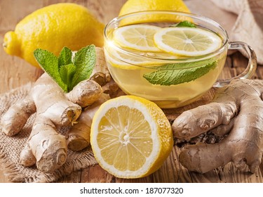 Ginger tea with lemon on a wooden table