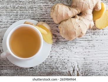 Ginger Tea In A White Cup On Wooden Background