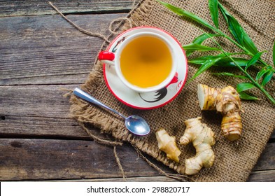 Ginger Tea In A White Cup On Wooden Background