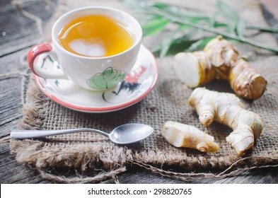 Ginger Tea In A White Cup On Wooden Background