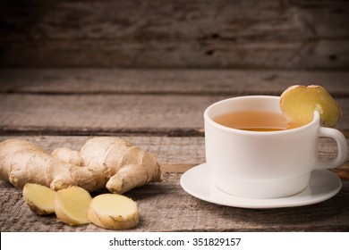 Ginger Tea In A White Cup On Wooden Background