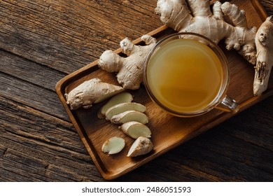 Ginger water with fresh ginger on wooden background