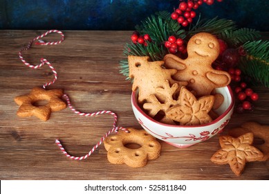 Gingerbread and christmas cookies in a bowl and festive decor on wooden background with a place for text - Powered by Shutterstock