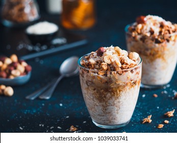 Gingerbread coconut overnight oatmeal served with granola,pecan,honey.Recipe and idea healthy vegan breakfast - plant-based milk overnight oats with chia and gingerbread spices cinnamon, nutmeg,ginger