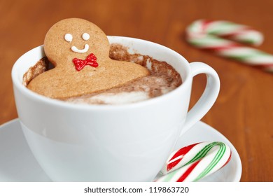 Gingerbread cookie man in a hot cup of cappuccino - Powered by Shutterstock