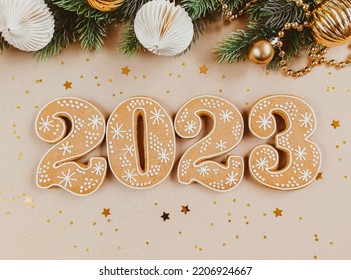 Gingerbread cookies in the form of numbers, gingerbread New Year 2023 and season festive decor on beige background . Top view. Flat lay - Powered by Shutterstock