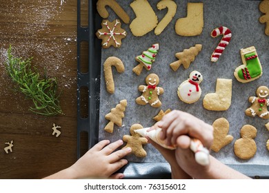 Gingerbread cookies getting decorated for Christmas