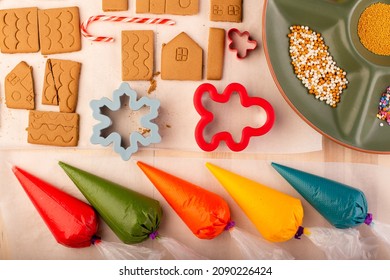 Gingerbread House Cookies Ready To Be Decorated With Coloured Royal Icing. Traditional Christmas Family Craft.